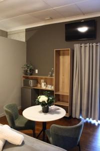 a living room with a table and chairs at Stay Local Potchefstroom in Potchefstroom
