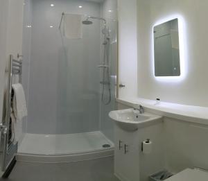 a white bathroom with a shower and a sink at The Claremont Preston in Preston +72 photos