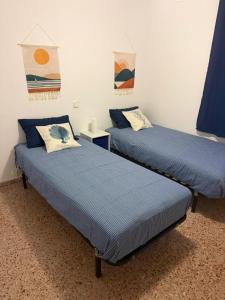 two beds sitting next to each other in a room at Ocean Breath Home in L'Ametlla de Mar