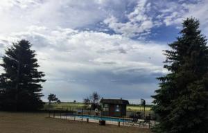 a park with a playground and a building and trees at North Winds Lodge LLC in Bowman