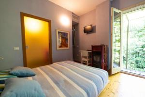 a bedroom with a large bed and a yellow door at Agriturismo Gallegati in Faenza