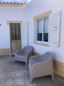 a room with two chairs and a window at Spacious House in Sagres with Private Patio & BBQ in Sagres