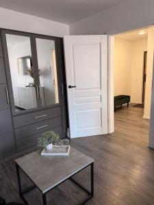 a living room with a door and a table with a table sidx sidx at Ventos g 51 Apartment in Mažeikiai