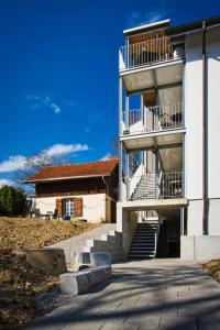 a white building with stairs and a stair case at Casa Carmela in Solothurn