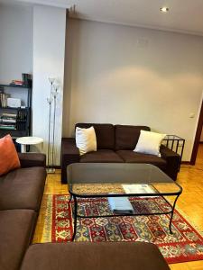 a living room with a couch and a coffee table at Avilés para Visitar in Avilés