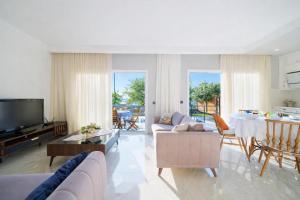 a living room with a couch and a table at Villa Riva in Oludeniz