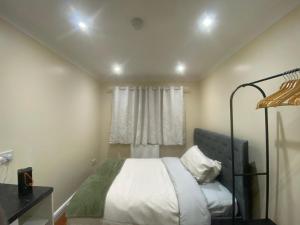 a bedroom with a bed and a window at Standish Haven Ensuite Room in Standish