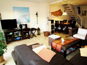 a living room with a couch and a dining room at Haus Pruchten in Pruchten