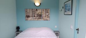 a bedroom with a bed and a painting on the wall at Corrèze rive Dordogne in Argentat +14 photos