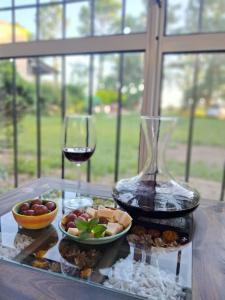 a table with a glass of wine and a plate of food at Anam Cara in Isla del Rincón