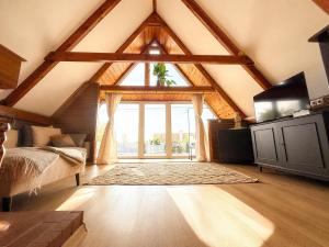 a attic room with a large window and a bed at Spicc house in Csopak