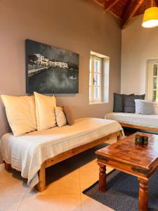 a living room with a couch and a table at Garys Old Farmhouse in Kamária