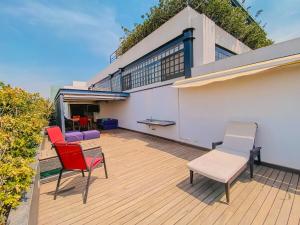 a balcony with chairs and tables on a building at Spacious modern and centrally located in Puebla