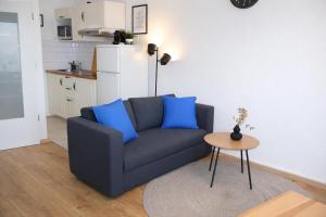 a living room with a blue couch and a table at Exklusive Studio-Apartments mit Balkon in Bad Rothenfelde