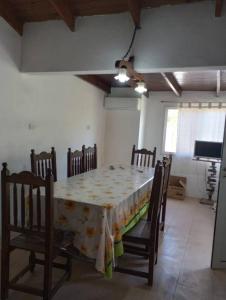 a dining room with a table and chairs in a room at El Rancho del Tucu in Colón