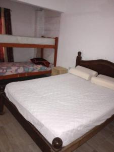 a bedroom with two bunk beds in a room at El Rancho del Tucu in Colón