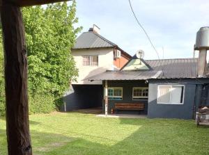 a house with a bench in front of it at El Rancho del Tucu in Colón