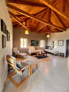 a large living room with couches and a table at Garys Old Farmhouse in Kamária