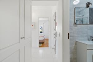 a white bathroom with a sink and a mirror at BC Beach House - Santa Cruz in Santa Cruz +57 photos