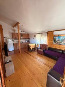 a living room with a couch and a table at Guest House „ Mountain Rest“ in Lilyanovo