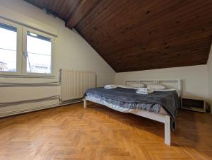 a bedroom with a bed and a wooden ceiling at Spacious Condo w Terrace & Piano in Sesvete