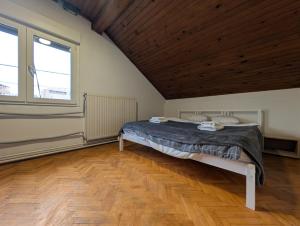 a bedroom with a bed and a wooden ceiling at Spacious Condo w Terrace & Piano in Sesvete