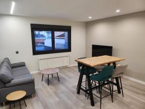 a living room with a table and a couch at CREDENCIAL Bulevar in Sarria
