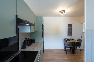 a kitchen and dining room with a table at la douceur voironnaise classé 3 étoiles in Voiron