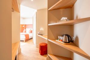 a room with a bedroom with a bed and a kitchen at Hôtel Villa Maïtia in Ustaritz +67 photos