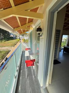 a porch with two chairs and a table at Drizzle Home - A Cosy Stay in Yercaud +72 photos