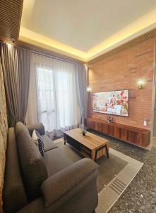 a living room with a couch and a coffee table at Villa Cassandra Atasha Private Resort - Celestine in Cuayan