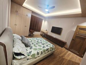a bedroom with a bed and a flat screen tv at Villa Cassandra Atasha Private Resort - Celestine in Cuayan +18 photos