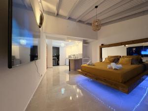 a bedroom with a large bed with a blue led floor at Les Terrasses du Fort in Basse-Terre