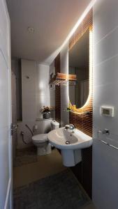 a bathroom with a sink and a toilet and a mirror at chez-moi sfax in Sfax +13 photos