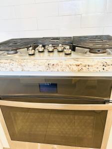 a stove top oven sitting in a kitchen at Cozy Private master bedroom in a single family house in Elk Grove