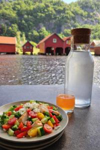 a plate of food on a table with a bottle of water at Stunning 3-Bedroom Apartment at Feda Waterfront in Feda
