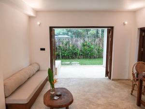 a living room with a couch and a table at Studio K Ahangama in Ahangama