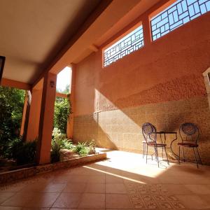 two chairs and a table on a patio at Momo's villa in Aït Ourir