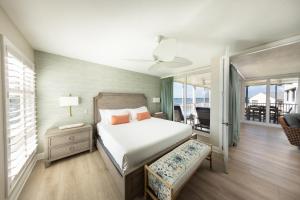 a bedroom with a bed and a balcony at Villas at Hawks Cay Resort in Duck Key +73 photos