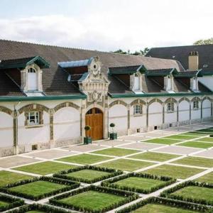 a large building with a garden in front of it at Le jardin secret in Reims