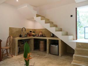 a kitchen with a staircase in a house at Studio K Ahangama in Ahangama +20 photos