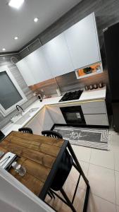 a kitchen with a wooden table and a stove at Chez-moi wiss in Sfax