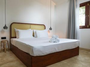 a bedroom with a bed with two towels on it at Studio K Ahangama in Ahangama