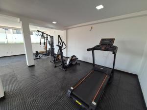 a gym with several treadmills and a treadmill at Airport subway apartment in Lauro de Freitas