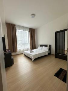 a bedroom with a bed and a large window at QH Guesthouse in Shah Alam +15 photos