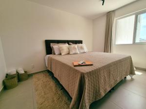 a bedroom with a bed with a tray on it at Airport subway apartment in Lauro de Freitas +43 photos