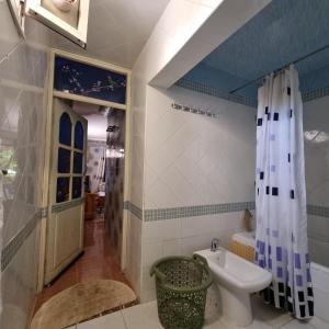 a bathroom with a sink and a toilet and a shower at Momo's villa in Aït Ourir +20 photos