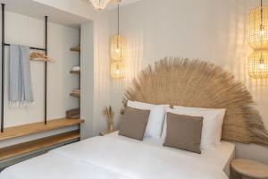 a bedroom with a white bed with a wooden headboard at Cavo Dio 8 - Beachfront bliss - Cozy Apt Pool Sunset in Káto Dhiminión