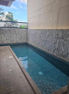 a swimming pool in the side of a building at Villa Cassandra Atasha Private Resort - Celestine in Cuayan