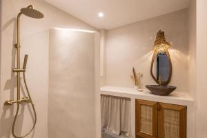 a bathroom with a shower and a mirror at Cavo Dio 8 - Beachfront bliss - Cozy Apt Pool Sunset in Káto Dhiminión +23 photos
